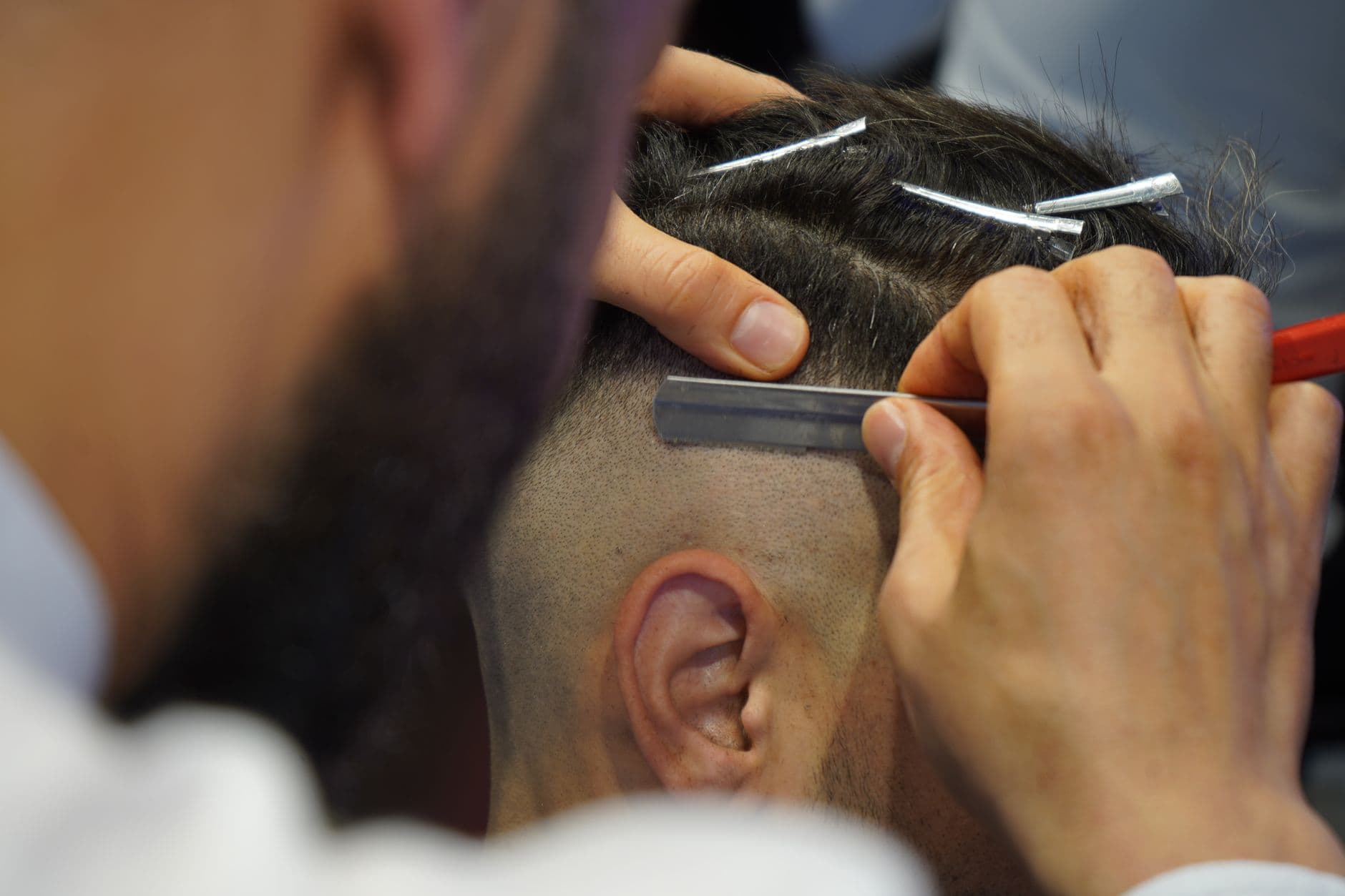 A barber detailing a clean neckline