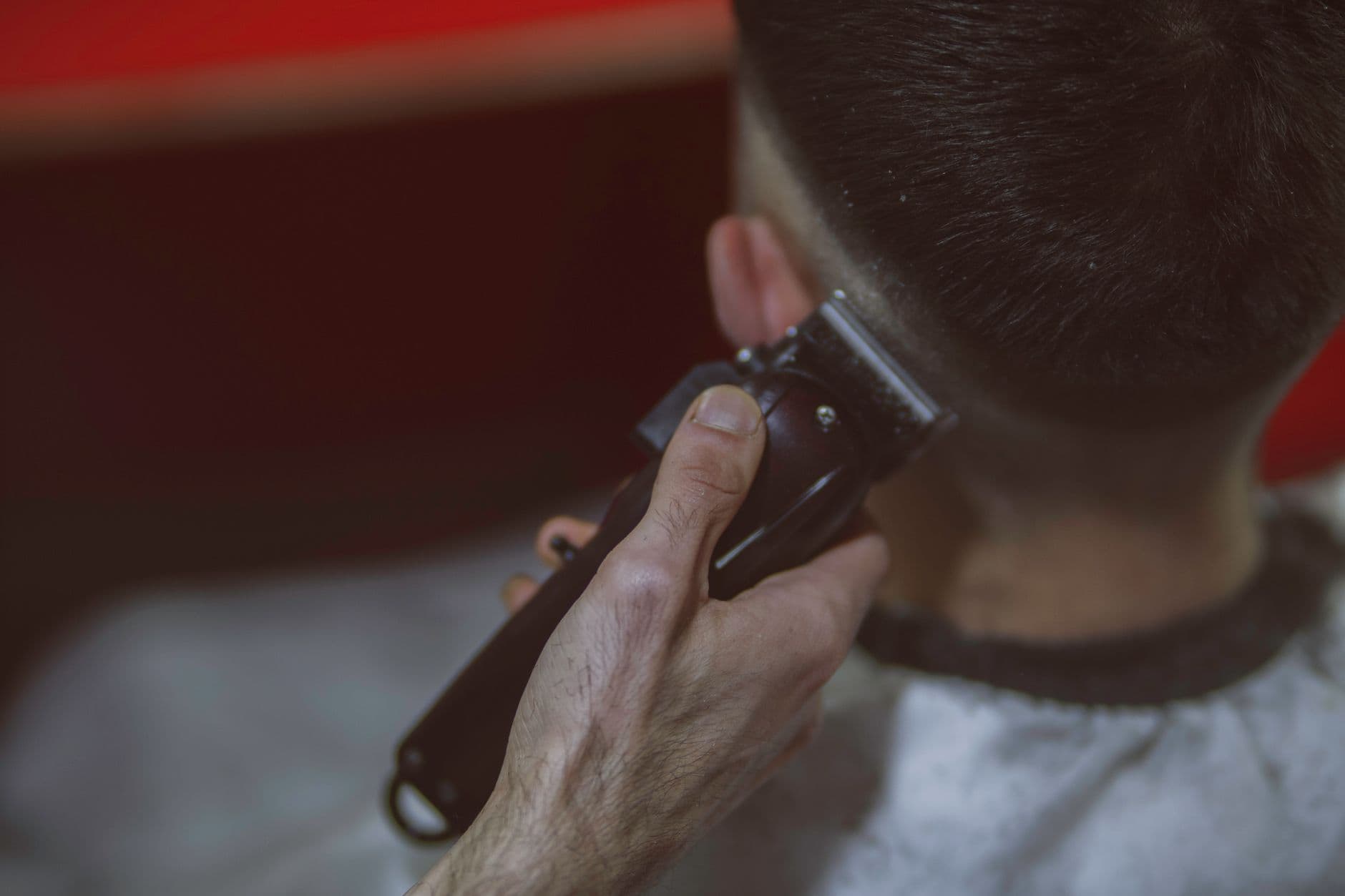 Close-up of a barber fading hair with clippers